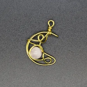Detailed view of handmade wire-wrapped rose quartz moon pendant