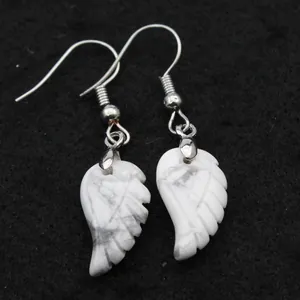 Detalle macro de elegantes pendientes colgantes de piedra natural howlita blanca