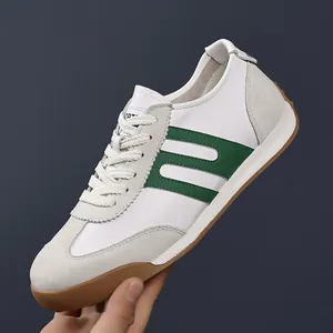 Classic retro white men's vintage trainer sneaker with green stripe and gum sole