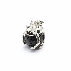 Detailed macro view of silver frog prince pendant holding a black natural lava stone bead
