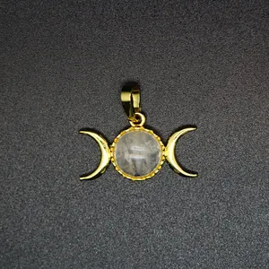 Detail view of 24K gold plated Triple Goddess pendant with central moonstone crystal