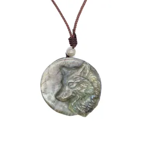 Detailed hand-carved wolf head profile on a natural iridescent labradorite crystal pendant