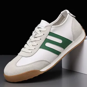 Detailed macro view of white leather men's sneakers with green stripes and gum sole