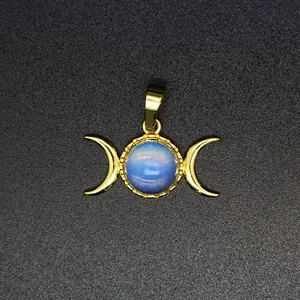 Detailed close-up of a triple moon goddess pendant with a blue celestial stone inlay.