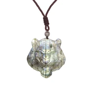 Detailed view of hand-carved labradorite tiger head pendant with blue flash.
