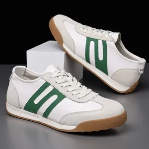 Close-up of white and green retro men's Gump sneakers with gum sole and suede details