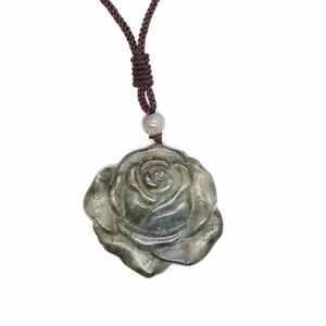 Detailed carving of a natural labradorite rose crystal pendant with braided cord