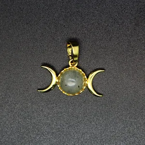 Detailed view of a 24K gold plated triple moon goddess pendant with natural grey stone