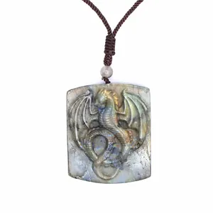 Close-up of hand-carved dragon pendant made from natural iridescent labradorite