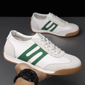 Detail of retro men's sneakers in white and green leather with gum soles