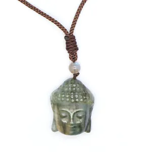 Close-up detail of a natural labradorite Buddha head pendant showing blue light flash.