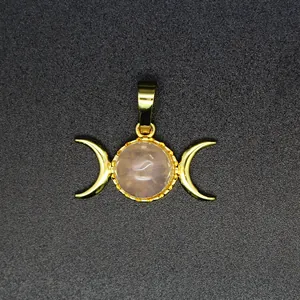 Close-up of a 24K gold-plated triple moon goddess pendant with rose quartz center.