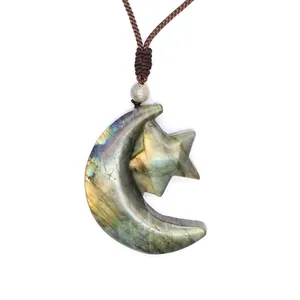 Detailed macro view of a natural labradorite necklace with carved moon and star pendant