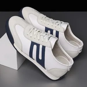 Detail view of men's white and blue Gump-style sneakers with premium suede overlays