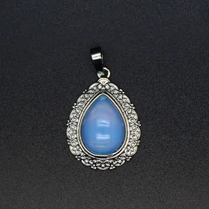 Detailed close-up of a teardrop stone pendant with elegant silver filigree frame