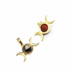 Close-up of 24K gold plated triple moon pendants with natural stone inlay details