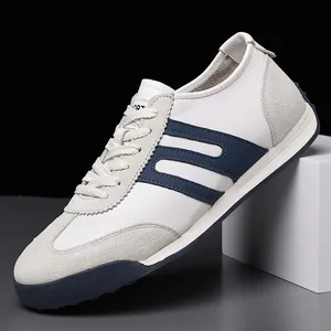 Detailed side view of premium white men's German Army Trainer shoes with navy blue stripes