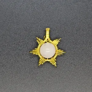 Detailed macro view of a handmade wire-wrapped sun pendant with a natural stone center