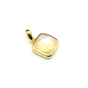Macro detail view of cushion-cut iridescent natural stone pendant with gold-plated frame