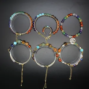 Detailed view of handmade chakra natural stone bracelets with 14K gold-filled chains and charms.