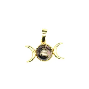 Detailed shot of a 24K gold plated triple moon goddess pendant with natural gemstone