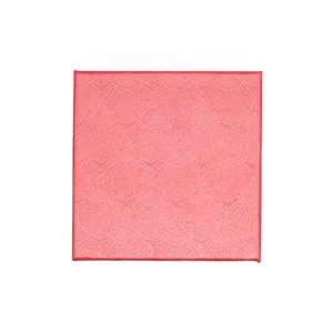 Top-down macro detail view of a square jewelry box featuring an elegant pink shell texture