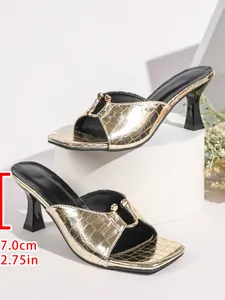 Close-up of gold crocodile-patterned sandals with a 7.0cm heel height measurement.