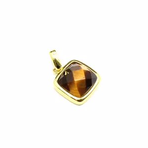 Detailed view of a square faceted tiger eye stone pendant with a polished gold bezel
