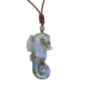 Detailed macro view of hand-carved natural labradorite seahorse pendant with blue flash