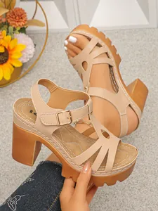 Close-up van elegante beige platform sandalen met een blokhak en een T-vormig riempje