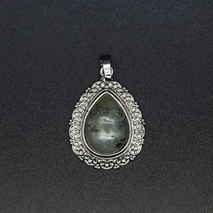Vintage teardrop natural stone pendant with intricate silver filigree border detail