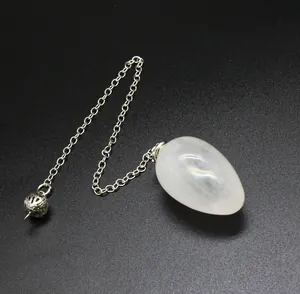 Close-up view of a white egg-shaped natural stone crystal pendulum with silver chain.