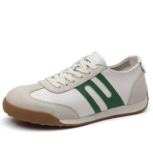 Vintage white leather and suede sneakers with green stripes and brown rubber sole