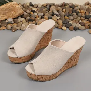 Suede peep-toe wedge mules for women featuring stylish cork-textured platform soles.