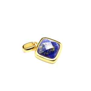 Close-up of a square faceted blue natural stone pendant with gold-toned setting.