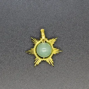 Close-up of hand-woven gold wire sun pendant with green natural stone, detail view