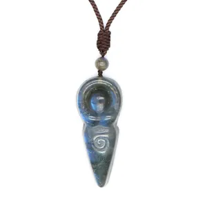 Detailed macro view of a natural Labradorite carved goddess pendant with blue flash
