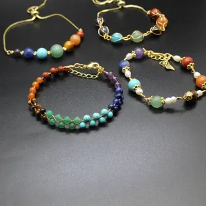 Detail view of four handmade chakra stone bracelets with 14K gold-filled accents.