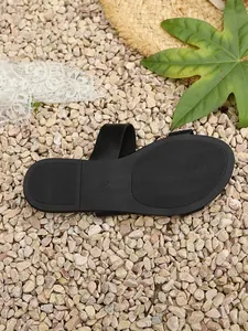Macro view of non-slip black rubber sole for women's summer beach sandals