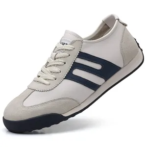 Detailed side view of men's white and navy blue casual sneakers with suede overlays