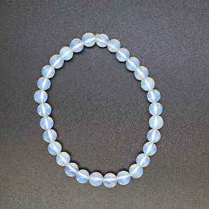 High-quality close-up of a 6mm translucent natural stone round bead bracelet on dark background
