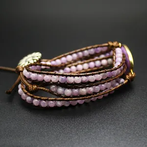 Macro view of handmade lavender stone beads woven into a brown cord wrap bracelet