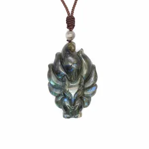 Detailed close-up view of a hand-carved Labradorite pendant with vibrant blue flash