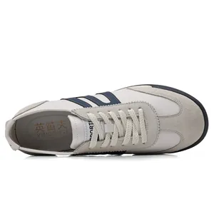 Top view of stylish men's casual trainers with blue stripes and suede toe details