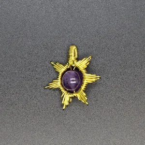 Detailed macro view of a handmade wire-wrapped sun pendant with purple amethyst stone