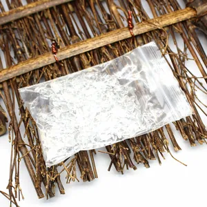 Close-up view of clear quartz crystal chips packed in a small transparent bag.
