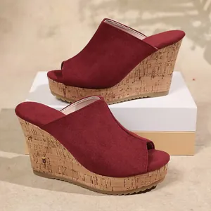 Side view of red suede peep-toe wedge sandals with stylish cork platform sole design.