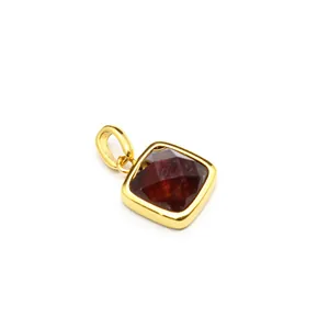 High-definition close-up of a square faceted natural stone pendant with a golden frame.