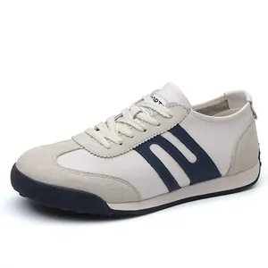 Detailed view of beige men's GAT sneakers with navy stripes and suede texture.