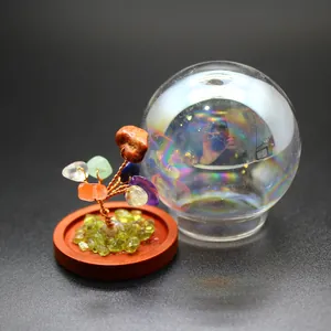 Detail view of miniature natural stone tree of life with glass dome cover